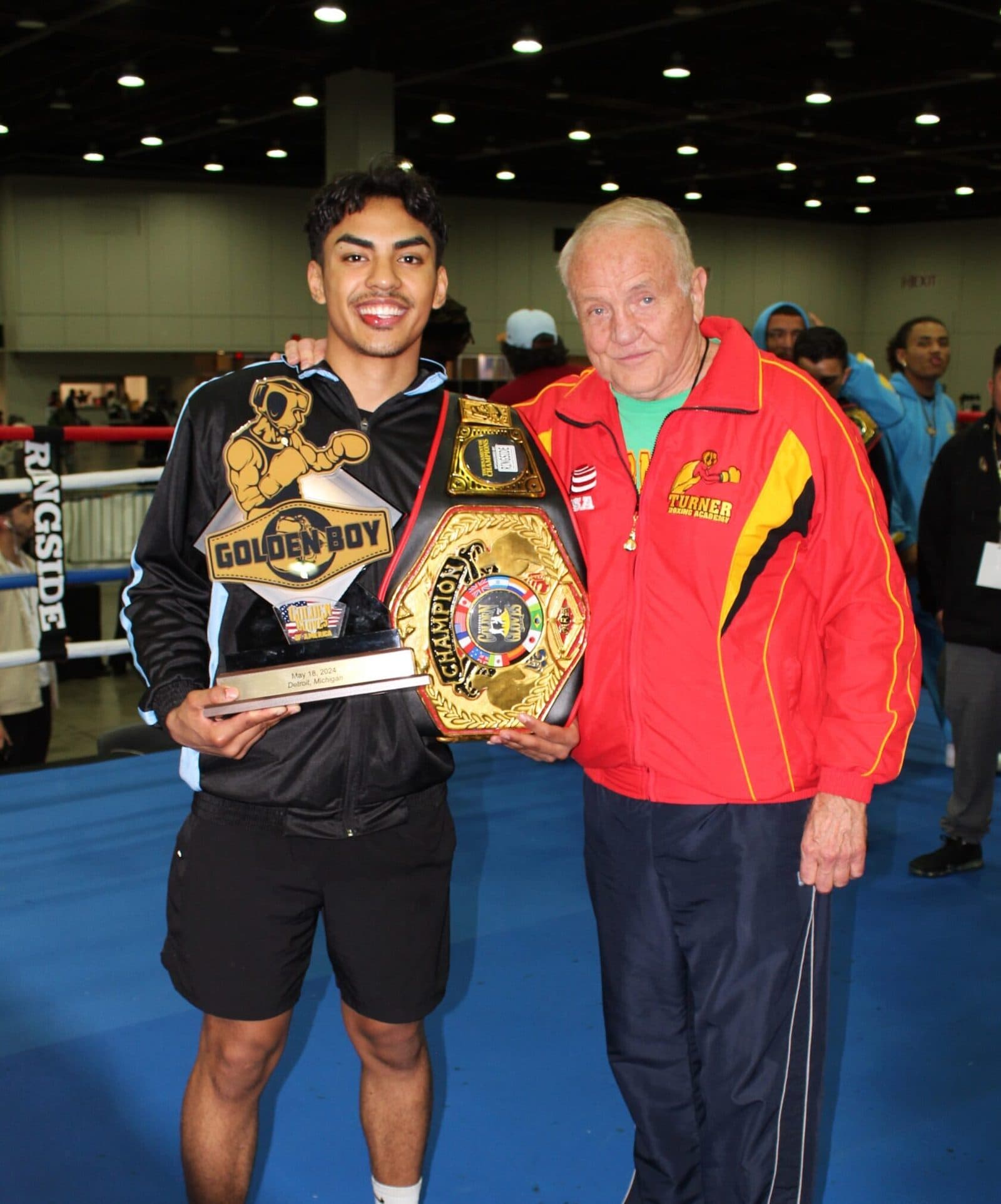 Marco Romero holds up his championship belt